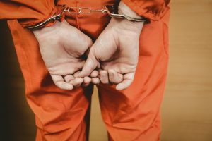 Cuffed man in jumpsuit