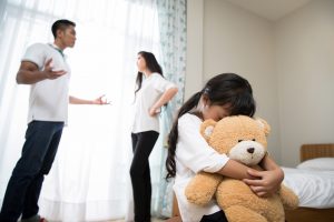 Scared child holding teddy bear